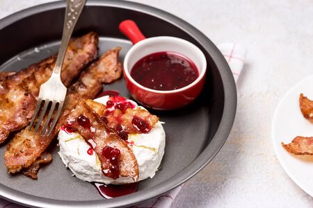 Roasted or Baked Camambert or Brie Cheese Baked with Bacon and Served with Cranberries Jam Keto Dietの写真素材