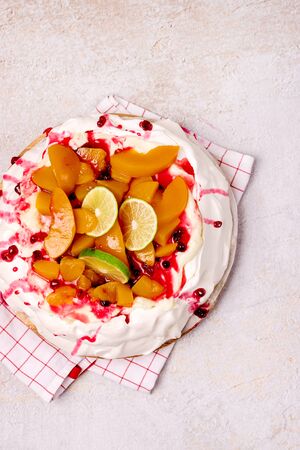 Pavlova Meringue Cake Decorated With Peach Berry Jam and Lime Tasty Homemade Dessert Top Viewの写真素材