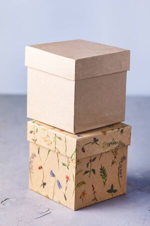 Two Craft Gift Boxes on Gray Background Holiday Concept Verticalの写真素材