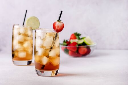Gasses of Cold Citrus and Strawberry Ice Tea Decorated with Slice of Lemon and Strawberry Healthy Summer Drink Horizontalの写真素材