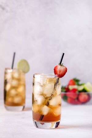 Gasses of Cold Citrus and Strawberry Ice Tea Decorated with Slice of Lemon and Strawberry Healthy Summer Drink Verticalの写真素材