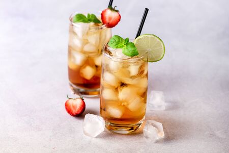 Gasses of Cold Citrus and Strawberry Ice Tea Decorated with Slice of Lemon and Strawberry Healthy Summer Drink Horizontalの写真素材
