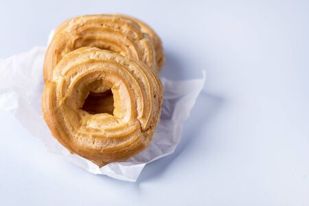 Tasty Home Baking Eclair with Cottage Cheese Tasty Homemade Dessert Blue Background Horizontal Copy Spaceの写真素材