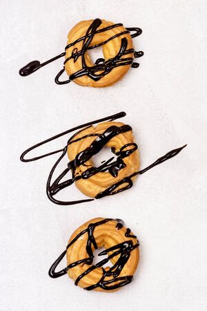 Tasty Home Baking Eclair with Cottage Cheese and Chocolate Sauce Tasty Homemade Dessert Top View Flat Lay Verticalの写真素材