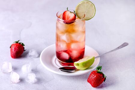 Glasses of Strawberries and Lime Ice Tea Refreshing Healthy Summer Drink Light Gray Background Horizontalの写真素材