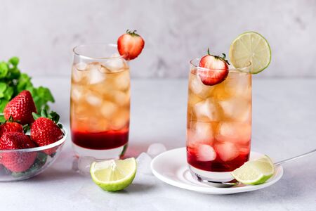 Glasses of Strawberries and Lime Ice Tea Refreshing Healthy Summer Drink Light Gray Background Horizontalの写真素材