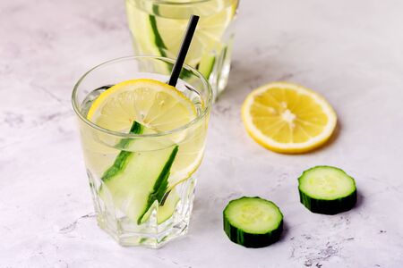 Glasses of Healthy Detox Water with Lemon and Cucumbers Diet Drink Straw Horizontal Aboveの写真素材