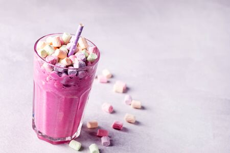 Glass of Tasty Fruit Smoothies or Milk Shake Decorated With Marshmallow Above Verticalの写真素材