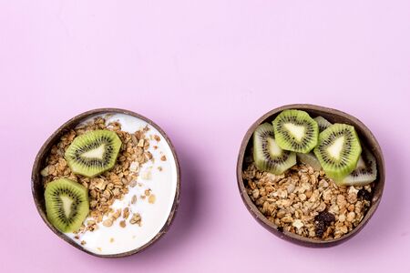 Coconut Bowl With Fresh Kiwi and Granola or Muesli Bowl of Homemade Granola for Healthy Breakfast Diet Food Top View Horizontalの写真素材