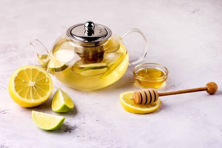 Teapot with Hot Citrus Tea Ripe Citrus and Honey Hot Drink Horizontal Healthy Drinkの写真素材
