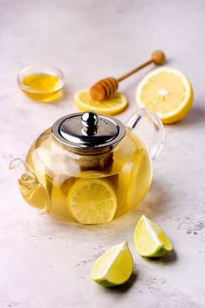Teapot with Hot Citrus Tea Ripe Citrus and Honey Hot Drink Vertical Healthy Drinkの写真素材