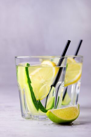 Glasses of Healthy Detox Water with Lemon and Cucumbers Diet Drink Straw Verticalの写真素材