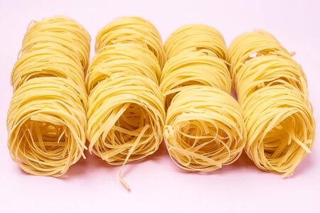 Group of Italian Egg Pasta Nest Tagliatelle Pink Background Italian Food Horizontalの写真素材