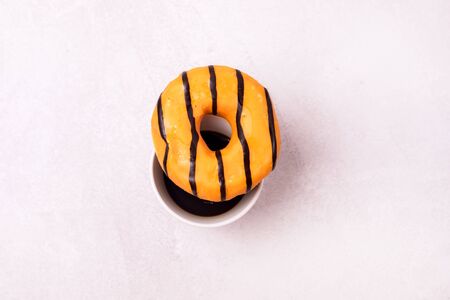 Tasty Homemade Orange Donuts with Cup Of Coffee Top View Flat Lay Breakfast Concept Morning Horizontalの写真素材