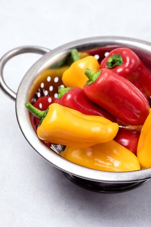 Set of Colored Bell Peppers in Bowl Ripe Peppers Gray Background Verticalの写真素材