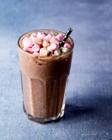 Glass of Tasty Chocolate Milk Shake with Marshmallow on Blue Background Tasty Cocoa Verticalの写真素材