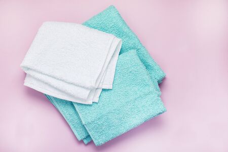 Pile of Towels Light Green and White Towels on Pink Background Top View Horizontalの写真素材