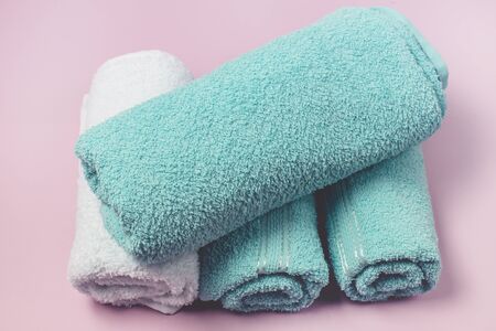 Pile of Towels Light Green and White Towels on Pink Background Top View Horizontalの写真素材