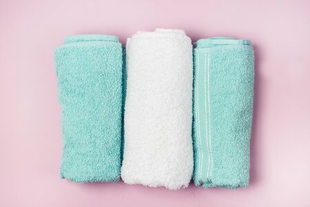 Two Light Green and White Towels on Pink Background Top View Horizontalの写真素材