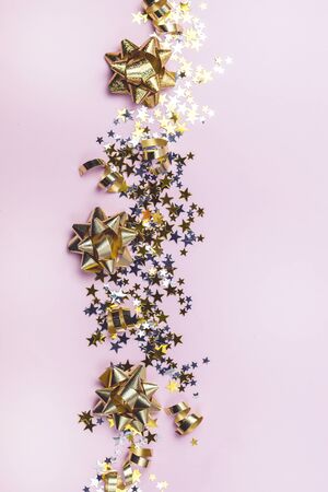 Gold and Silver Confetti in Shape of Stars on Pink Background Sparkly Background Holiday Celebration Concept Festive Background New Year Verticalの写真素材