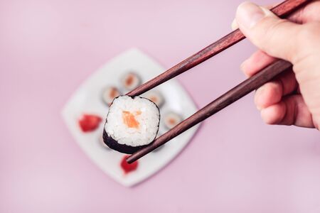 Female Hand Holding Sushi Japanese Food Sushi with Salmon Top View Horizontalの写真素材