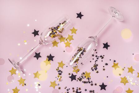 Christmas or New Year Holidays Background with Confetti and Two Champagne Glasses Top View Festiveの写真素材