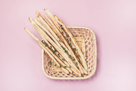 Homemade Cheese or Bread Sticks with Herds Crispy Bread Sticks with Thyme and Rosemary on Pink Background Top View Horizontalの写真素材