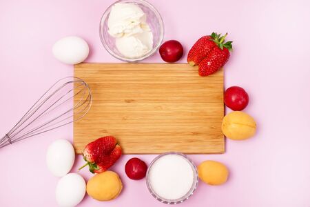 Eggs Whites Cream Cheese Whisk Sugar Fruits and Strawberry Ingredients for Pavlova Cake Step by step Recipe of Pavlova Cake Top View Frameの写真素材