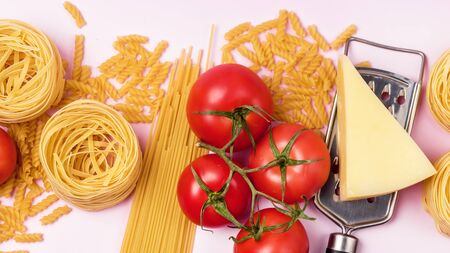 Italian Food Ingredients on Pink Background Variety of Pasta Cheese Tomato Top View Long Italian Food Backgroundの写真素材