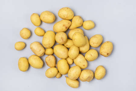Heap of Raw Young Potatoes on Blue Background Top View Horizontalの写真素材