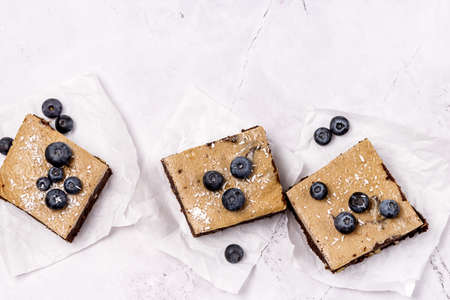 Pieces of Homemade Chocolate Brownies Decorated with Ripe Blueberry on Gray Background Tasty Chocolate Dessertの写真素材