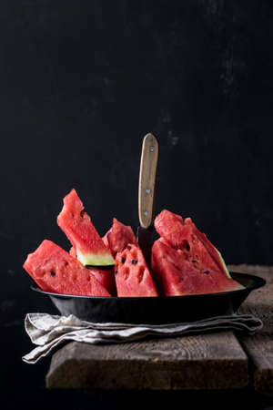 Slices of Tasty and Juicy Watermelon Served on Black Plate Dark Photo Wooden Background Healthy Diet Foodの写真素材
