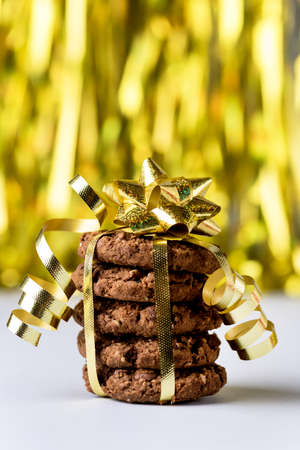 Christmas Chocolate Chip Cookies Decorated with Gold Ribbon on Blue Background Sweet Gift for Christmas Vertical Blue Backgroundの写真素材