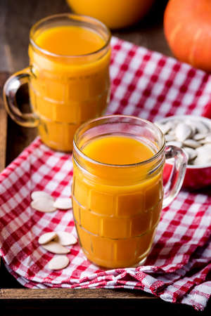 Glasses of Tasty Pumpkin Smoothie or Healthy Pumpkin Juice Healthy Detox Drink Autumn Beverage Verticalの写真素材
