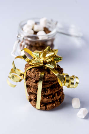 Christmas Chocolate Chip Cookies Decorated with Gold Ribbon on Blue Background Sweet Gift for Christmas Vertical Blue Backgroundの写真素材