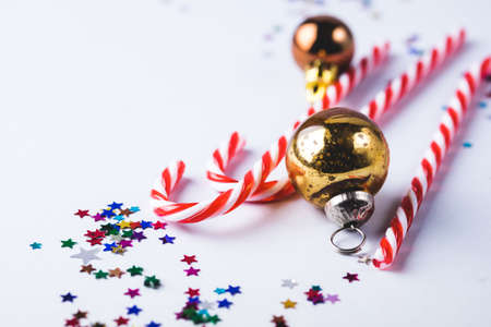 Christmas or New Year Background with Gold Christmas Balls Confetti and Candy Cane on Blue...