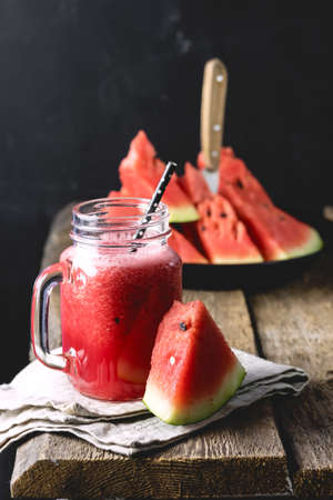 Glass Jar of Tasty Watermelon Smoothie on Wooden Background Vertical Healthy and Tasty Summer Drinkの写真素材
