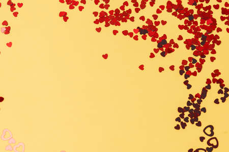Colorful Celebration Background with Party Confetti in Shape of Heart on Yellow Background Flat Lay Holiday Background Top View Horizontal Copy Spaceの写真素材
