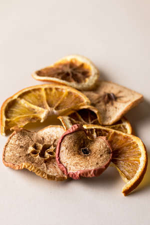 Subtle Fruit Chips Orangand Apple Chips on Yellow Background Close Up Verticalの写真素材