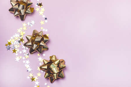 Gold and Silver Confetti in Shape of Stars on Pink Background Sparkly Background Holiday Celebration Concept Festive Background New Yearの写真素材