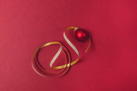 Christmas or New Year Card or Background Red Christmas Ball and Golden Thread Red Background Top...
