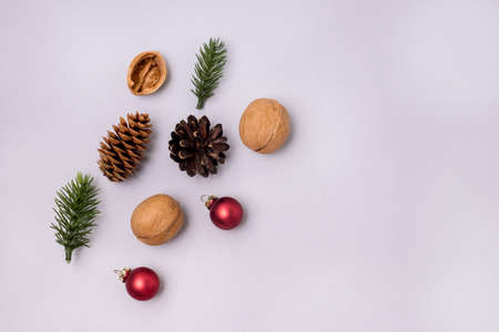Christmas Background with Red Christmas Balls Fir and Nuts on Blue Background on Blue Background Top View Copy Spaceの写真素材