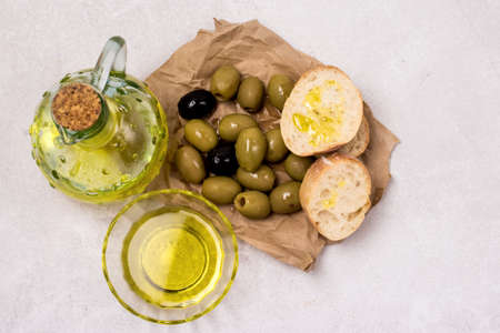 Olive Oil and Olives and Bread on Gray Background Top Viewの写真素材
