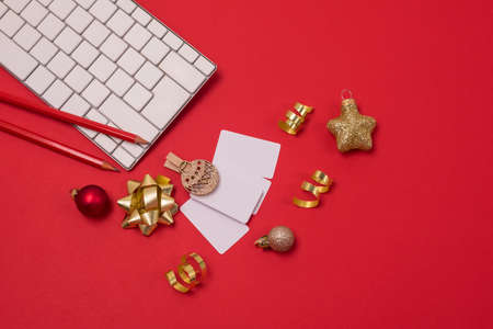 Christmas Blogger Background Red Pencils White Keyboard Gold Confetti and Christmas Balls Red Background Top View Horizontalの写真素材