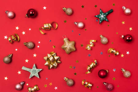 Red Background with Holiday Christmas Decoration Balls Confetti Christmas Wallpaper Flat Lay Top View Horizontalの写真素材