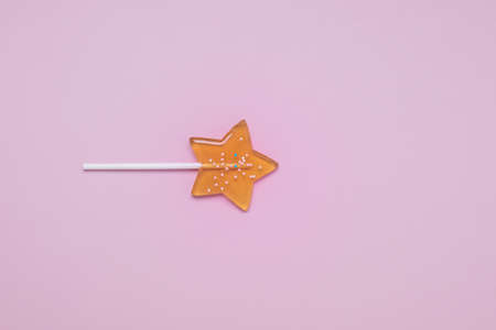Yellow Star Shaped Lollipop on Light Pink Background Homemade Fruit Lollipop Candy Background Flat Lay Top View Long Bannerの写真素材