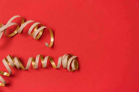 Gold Ribbon Banner on Christmas Red Background Copy Space Horizontalの写真素材