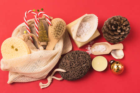 Holiday Christmas Gift Natural Soaps Bamboo Face Brush Golden Confetti Red Background Copy Spaceの写真素材