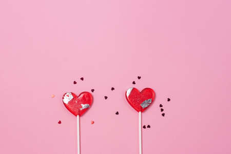 Two Lollipops Hearts Red Confetti Candy Love Concept Valentine Day Copy Spaceの写真素材