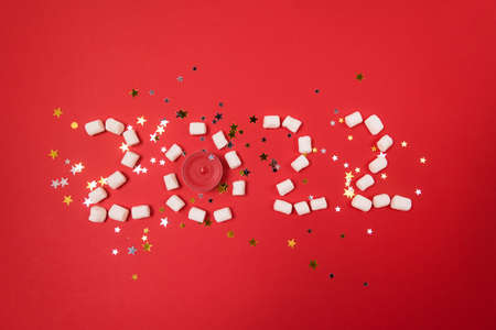 2022 Made From Little Marshmallow and Red Candle Red Background Happy New Year Goals and Lifestyle Concept Horizontal Confettiの写真素材